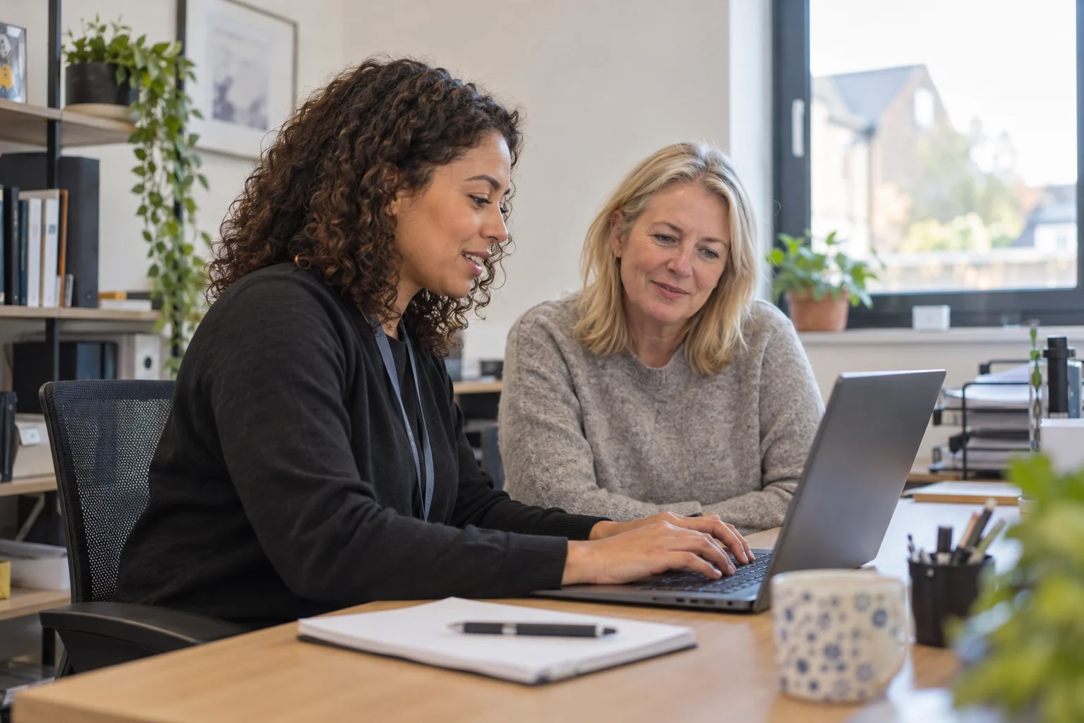 Illustrative onsite IT specialist supporting a business user with a laptop